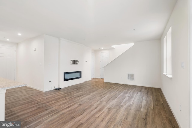 unfurnished living room featuring hardwood / wood-style flooring