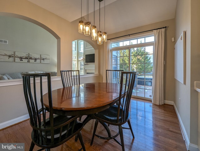 dining room with hardwood / wood-style floors and a notable chandelier