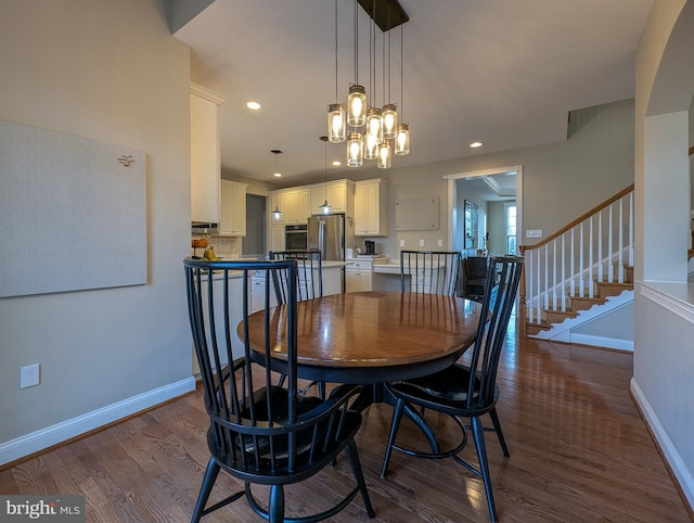 dining area featuring a notable chandelier and dark hardwood / wood-style floors