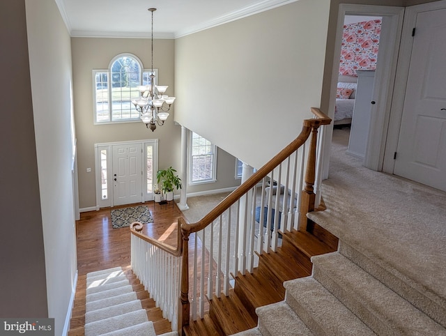 foyer entrance featuring hardwood / wood-style floors, an inviting chandelier, and crown molding