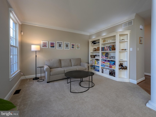 living room with ornamental molding and light colored carpet