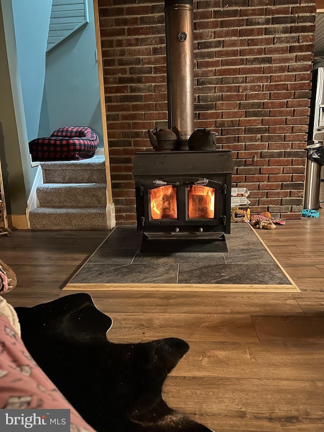 details featuring wood-type flooring and a wood stove