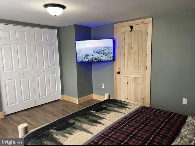 bedroom with hardwood / wood-style flooring and a closet