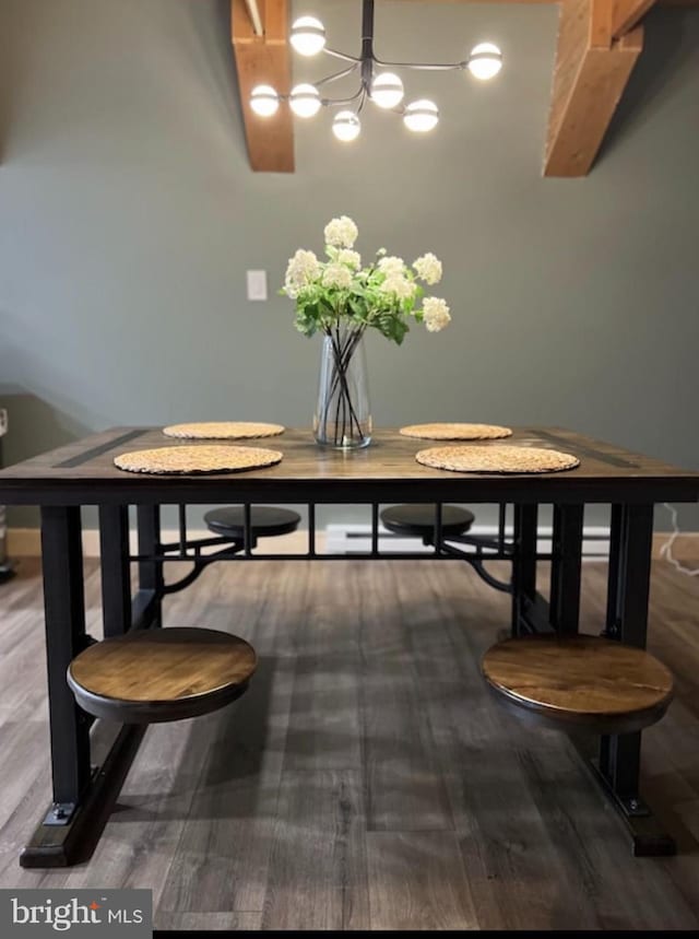 dining room with hardwood / wood-style floors and an inviting chandelier