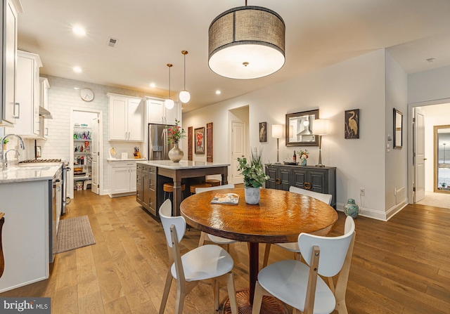 dining room with light hardwood / wood-style floors and sink