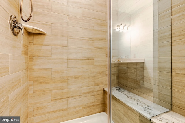 bathroom with a tile shower