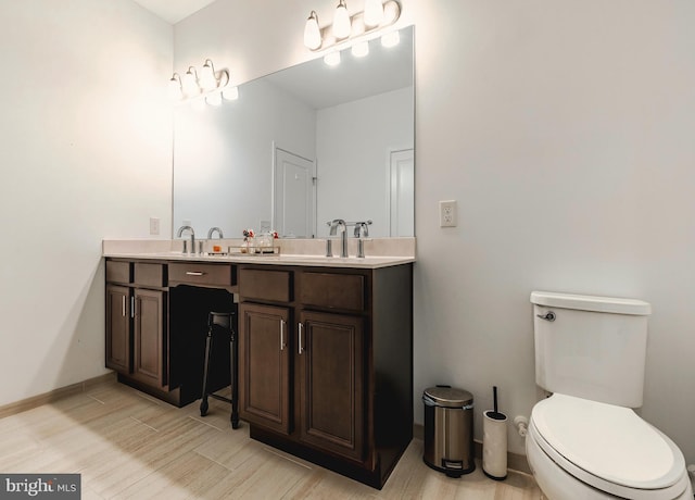 bathroom with toilet and vanity