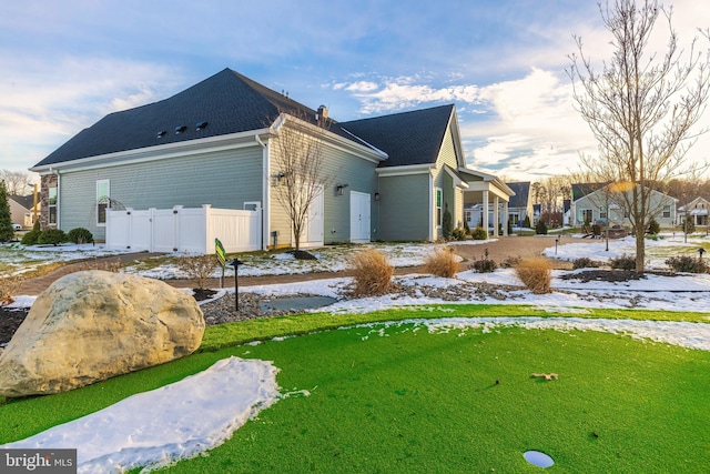 snow covered property featuring a yard