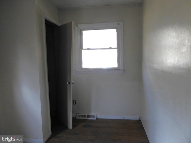 empty room with dark wood-type flooring