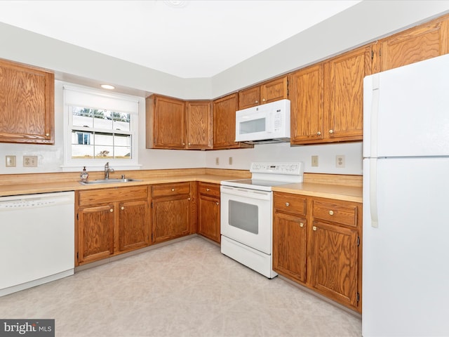 kitchen featuring white appliances and sink