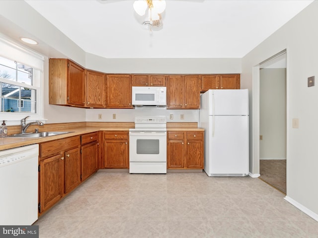 kitchen with ceiling fan, white appliances, and sink