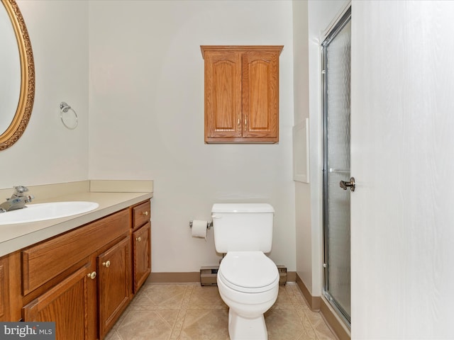 bathroom with vanity, toilet, a shower with shower door, and a baseboard heating unit