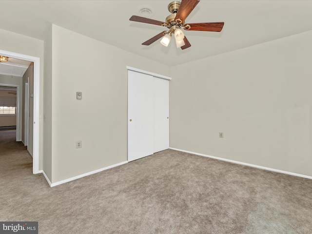 unfurnished bedroom with a closet, ceiling fan, and carpet