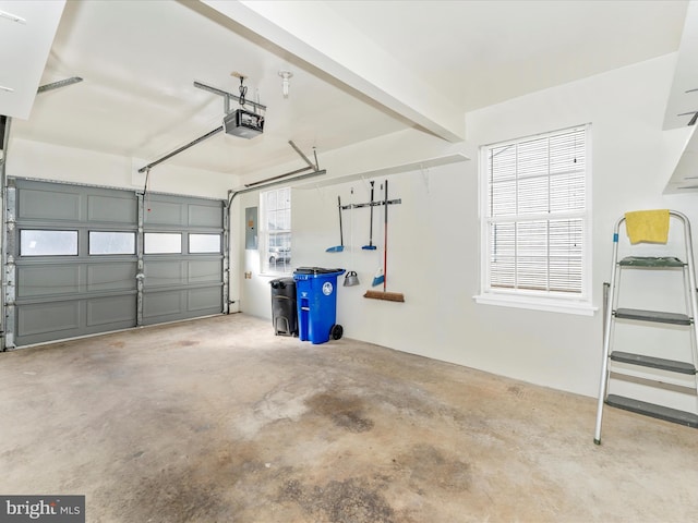 garage with a garage door opener and electric panel