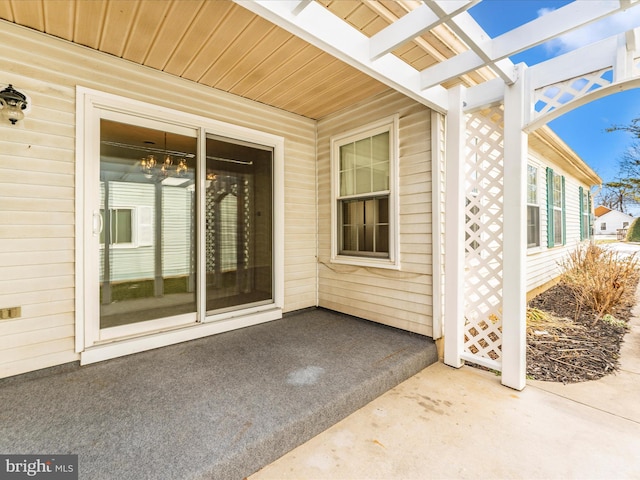 doorway to property with a pergola and a patio