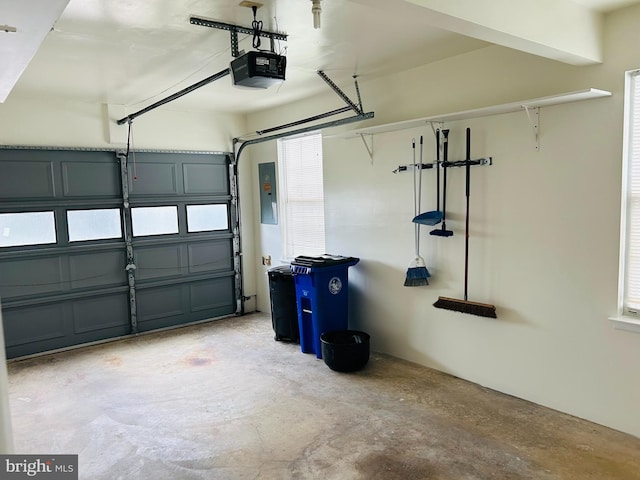 garage with a garage door opener and electric panel