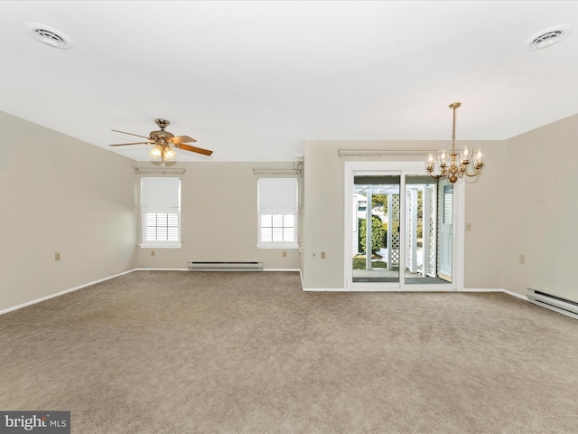 unfurnished room with baseboard heating, carpet flooring, ceiling fan with notable chandelier, and a wealth of natural light