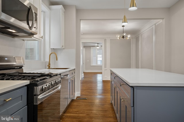 kitchen featuring white cabinets, gray cabinets, and stainless steel appliances