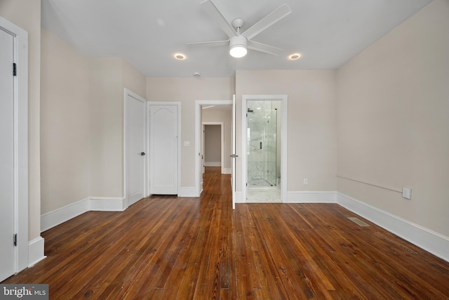 unfurnished bedroom with ensuite bathroom, ceiling fan, and dark hardwood / wood-style flooring