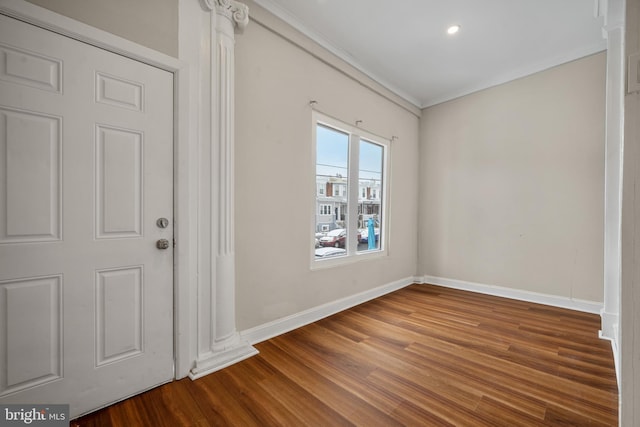 foyer with wood-type flooring and ornamental molding