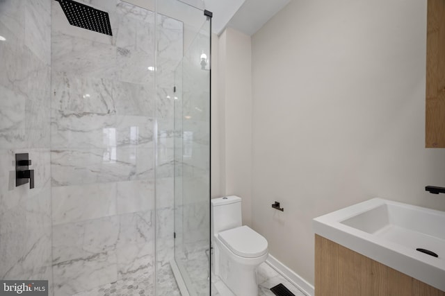 bathroom featuring a shower with door, vanity, and toilet