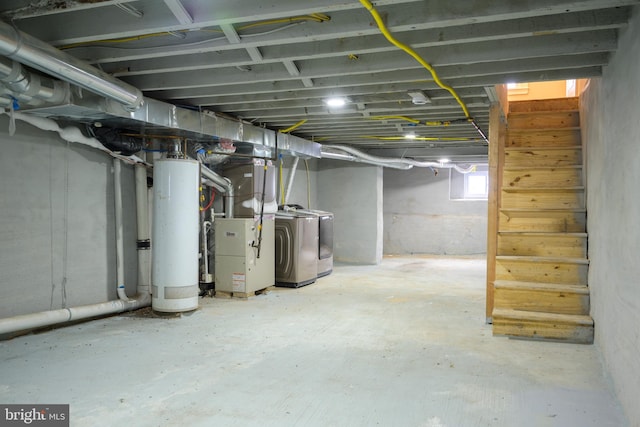 basement featuring independent washer and dryer, gas water heater, and heating unit