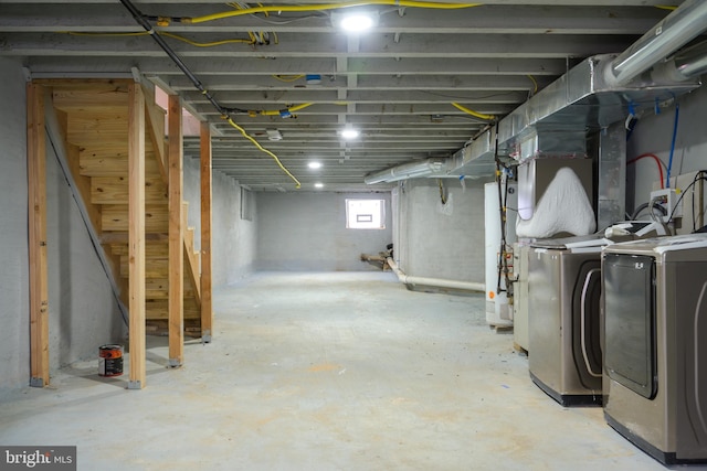 basement featuring independent washer and dryer and water heater