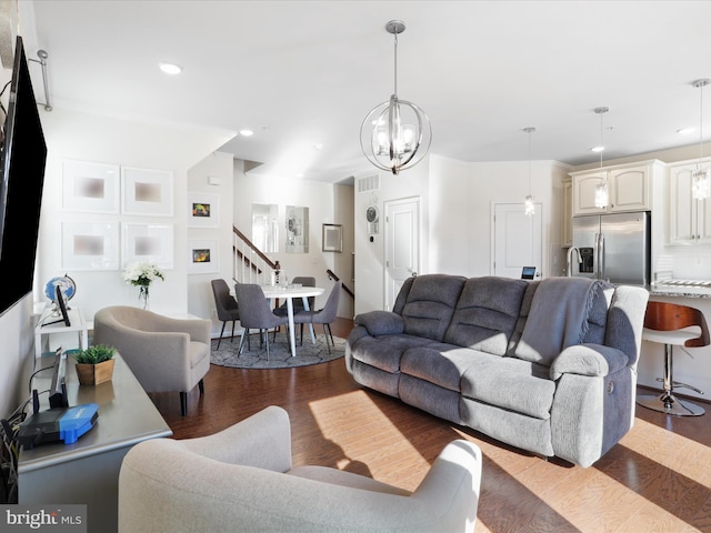 living room with an inviting chandelier and dark hardwood / wood-style floors