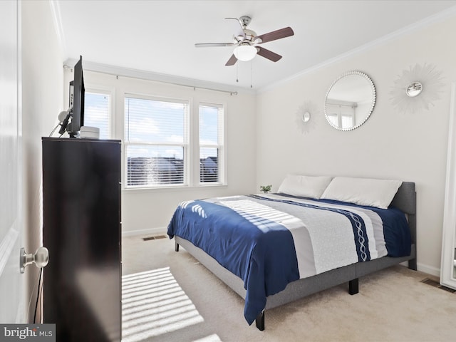 bedroom featuring light colored carpet, ceiling fan, and crown molding