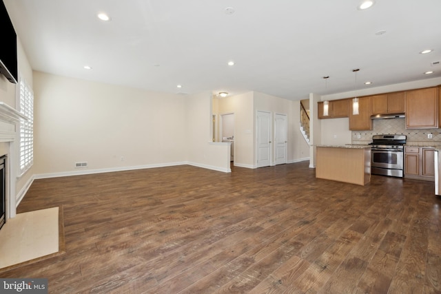 unfurnished living room with a premium fireplace and dark hardwood / wood-style floors