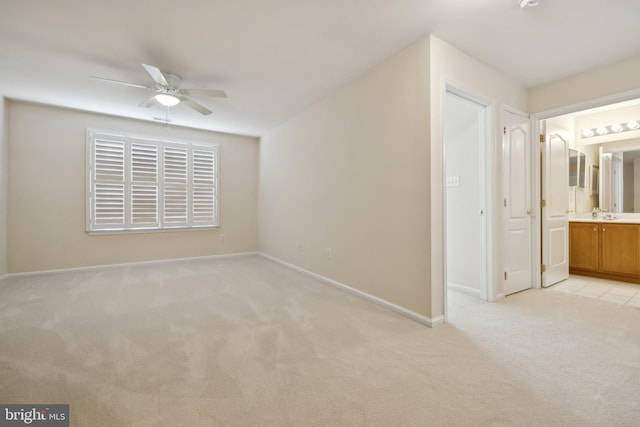 interior space with light carpet and ceiling fan