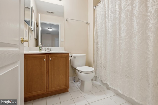 bathroom with vanity, tile patterned flooring, and toilet