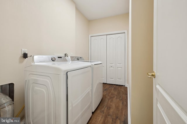 clothes washing area with washing machine and dryer and dark hardwood / wood-style floors