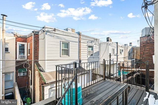 wooden deck featuring central AC unit