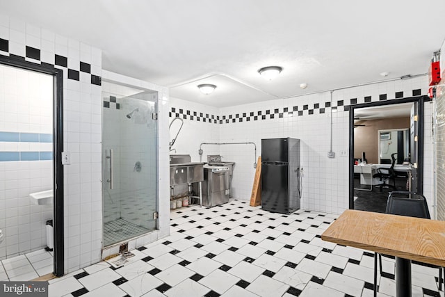 bathroom featuring an enclosed shower and tile walls