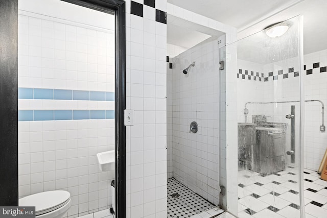 bathroom with toilet, tile walls, and walk in shower