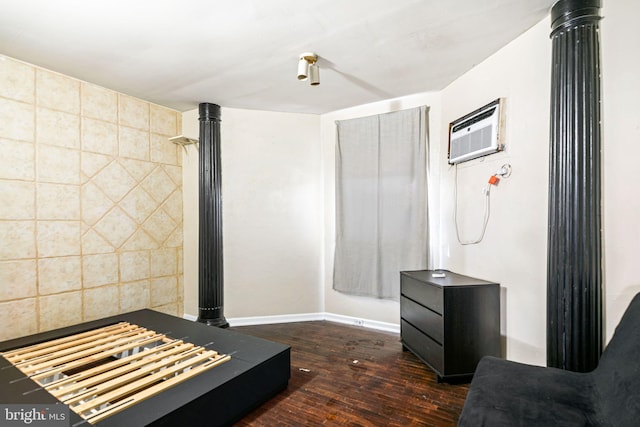 interior space featuring a wall mounted air conditioner and dark hardwood / wood-style floors