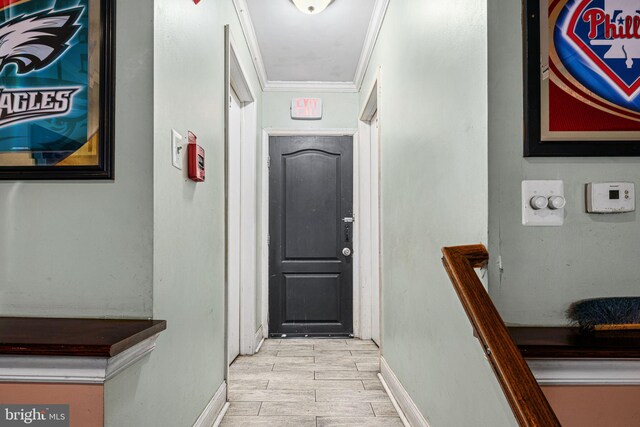 hallway featuring crown molding