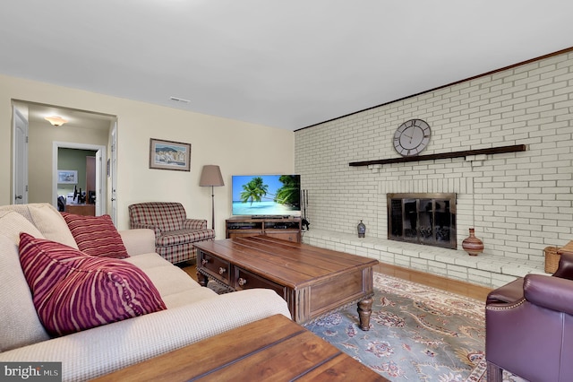 living room featuring hardwood / wood-style flooring and a fireplace