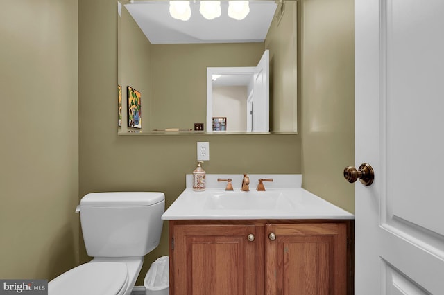 bathroom featuring toilet and vanity