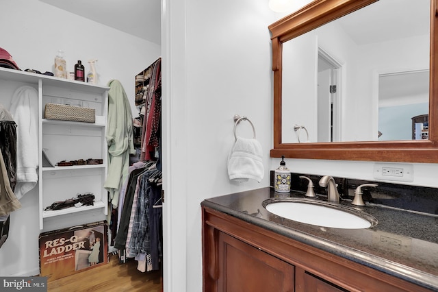 bathroom with hardwood / wood-style flooring and vanity