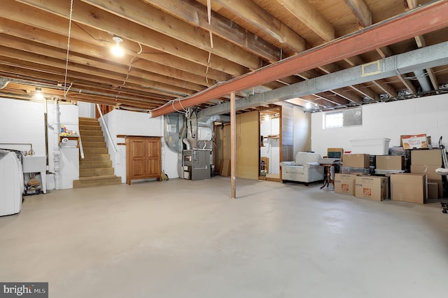 basement with washer / dryer, heating unit, and sink