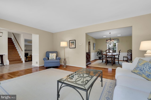 living room with hardwood / wood-style floors and a notable chandelier