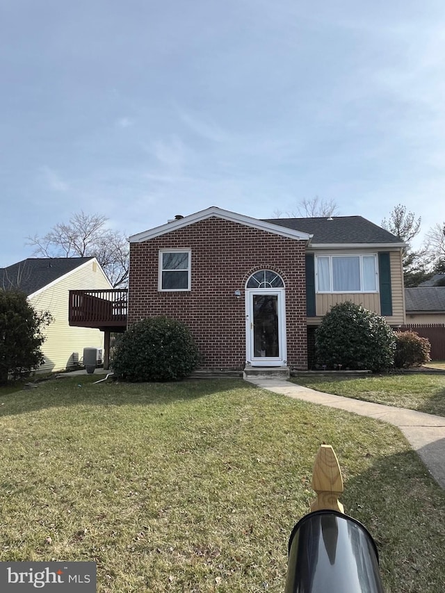 view of front facade with a deck and a front lawn