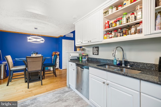 kitchen featuring dishwasher, sink, decorative light fixtures, white cabinets, and light wood-type flooring