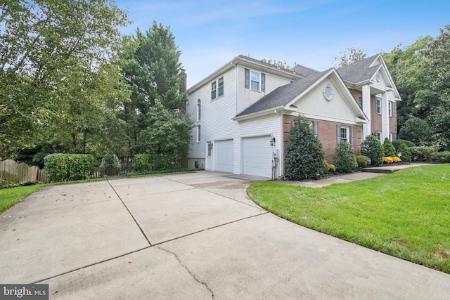 view of property exterior featuring an attached garage, brick siding, fence, a yard, and a chimney