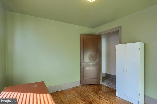 unfurnished bedroom featuring dark hardwood / wood-style flooring