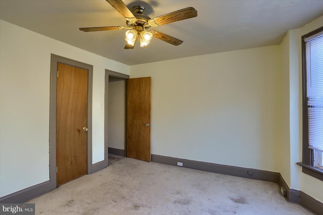 spare room featuring ceiling fan and light colored carpet