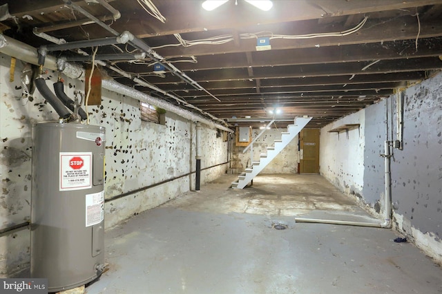 basement with electric water heater and electric panel