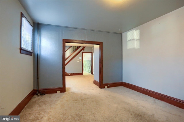 carpeted spare room featuring a wealth of natural light